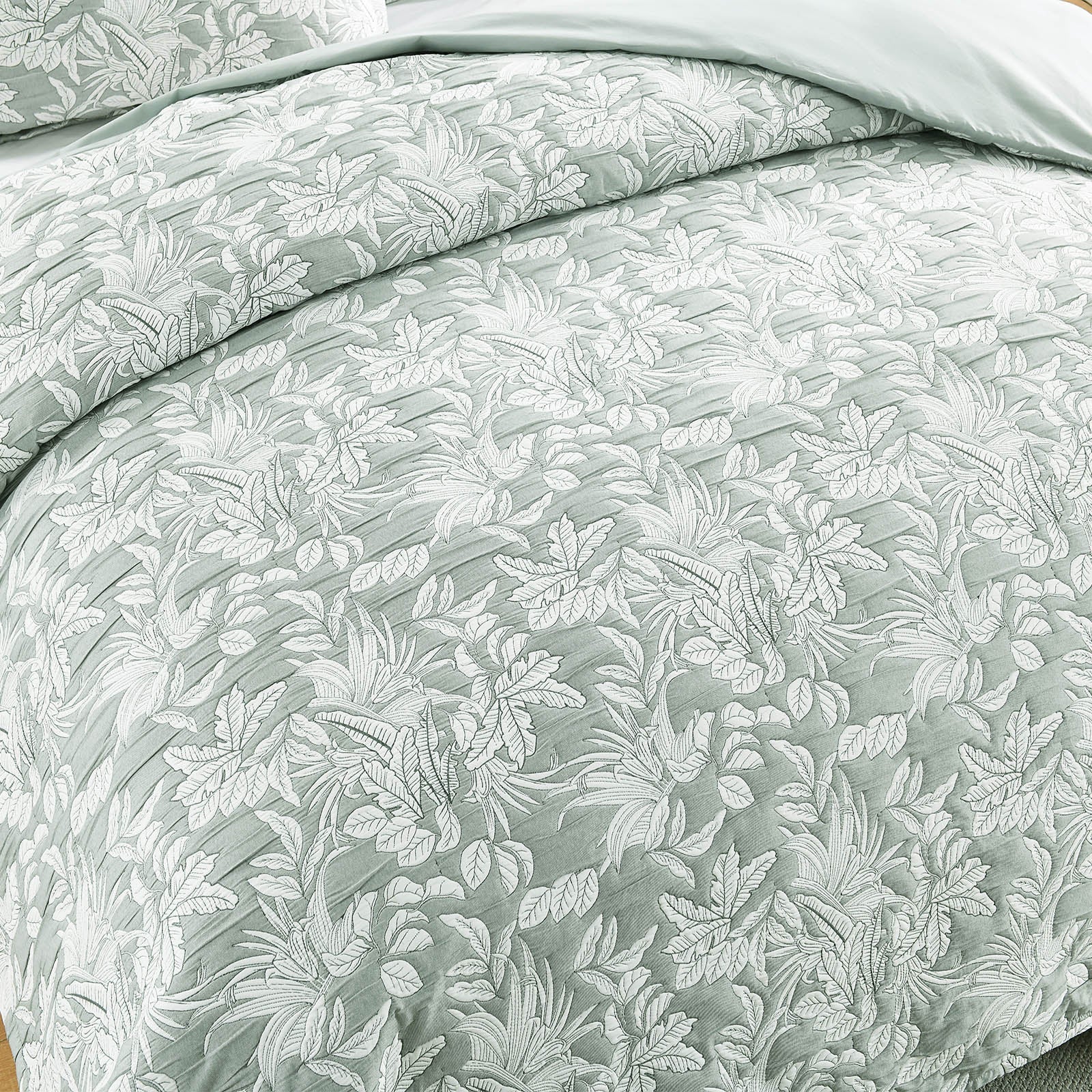 Green Indiana jacquard quilt cover set on a bed showing textured cotton matelasse weave — view 3
