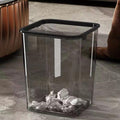 Transparent square waste bin with internal press-ring mechanism, shown empty on a white background.