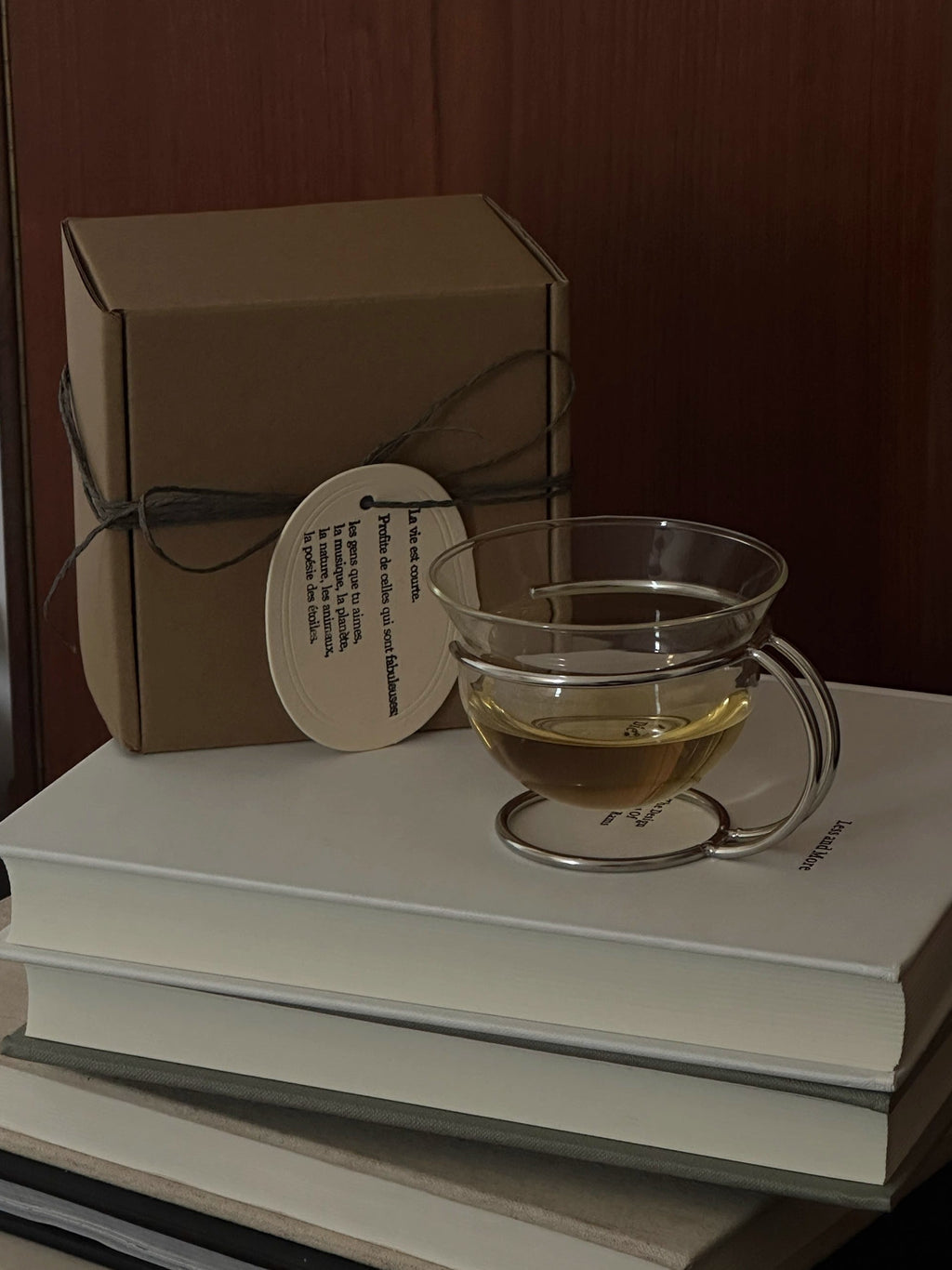 Clear vintage glass coffee cup resting in a sleek minimalist stainless steel wire holder — view 4