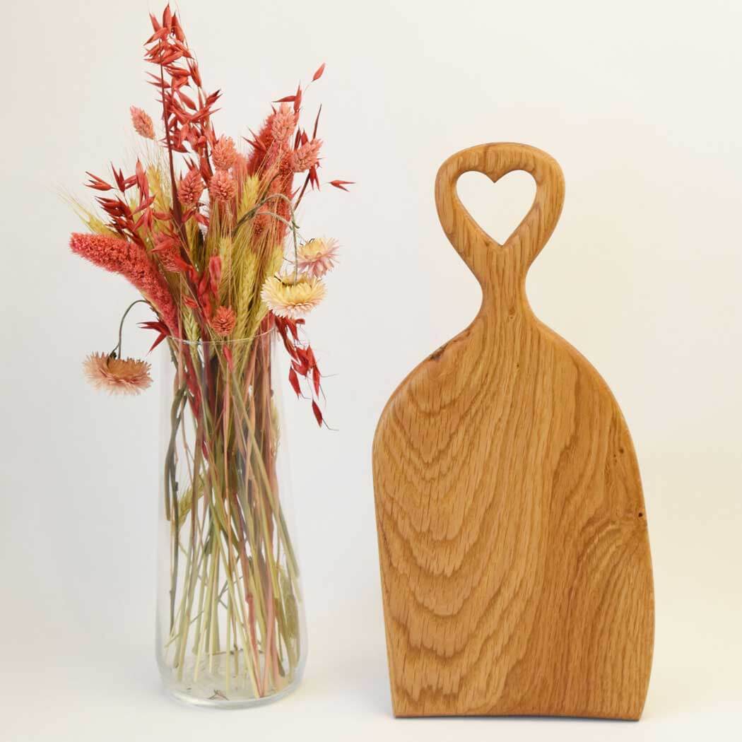 Handcrafted oak cutting board displaying natural wood grain on a clean kitchen countertop. — view 3