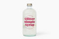 Glitter simple syrup in a sixteen ounce bottle, shimmering liquid for artisanal cocktails and mocktails