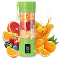 Green portable electric fruit juicer with carrying rope and stainless steel blades for travel smoothies.