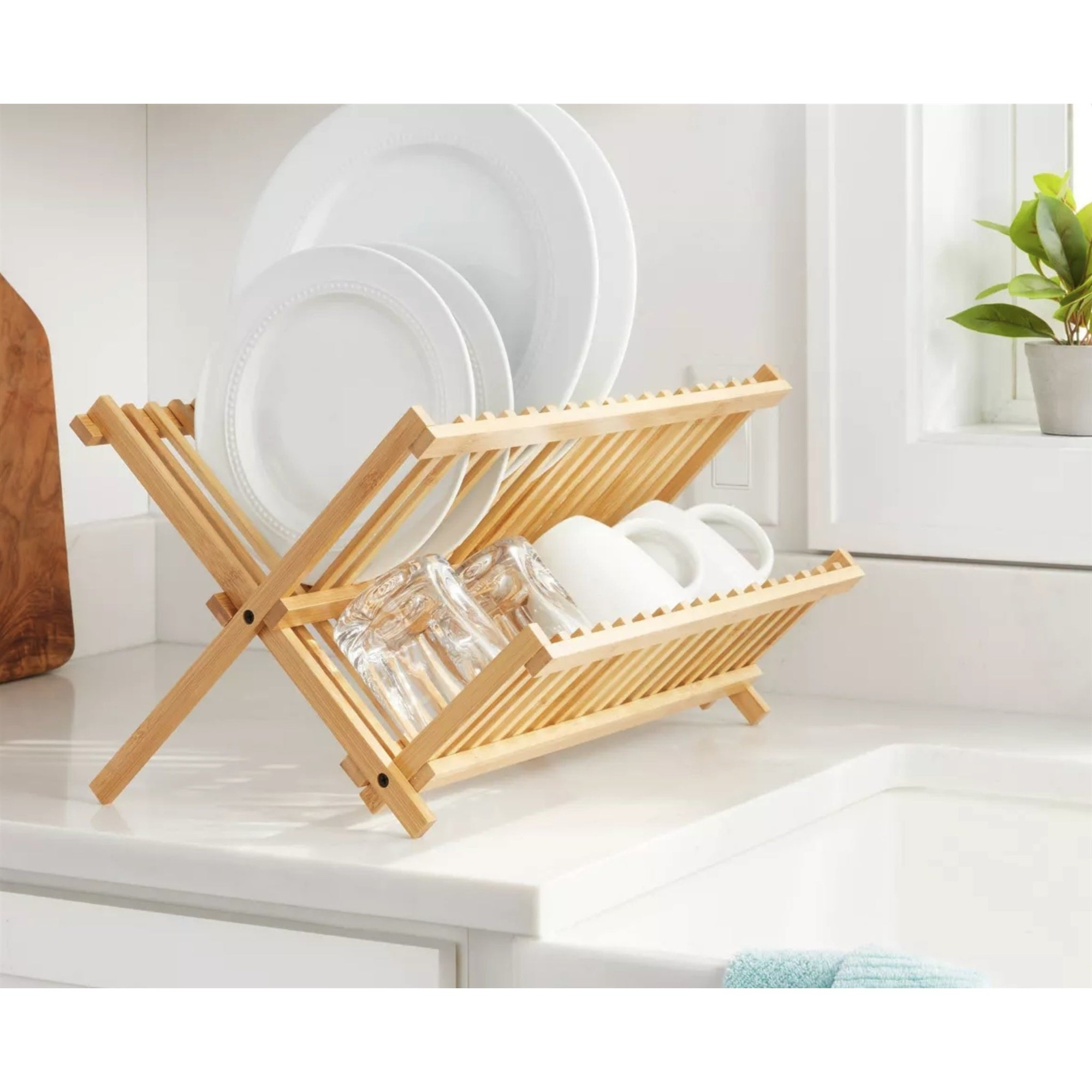 Two-tier foldable natural bamboo dish drying rack organizing plates and cups on a kitchen counter — view 2