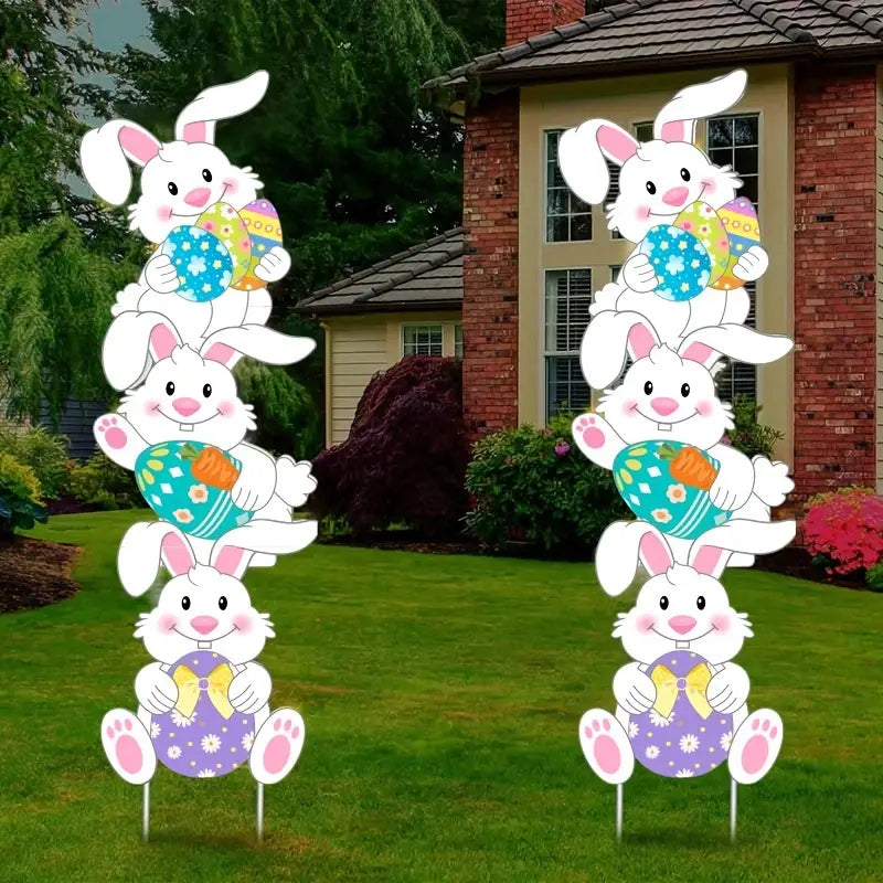 Tumbling bunnies yard stakes made of corrugated plastic displayed on a green grass lawn. — view 3