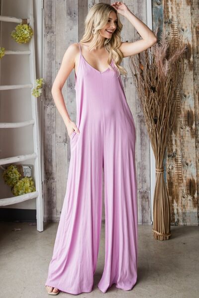 Women's V-neck wide leg jumpsuit with spaghetti straps, side pockets, and tied detailing