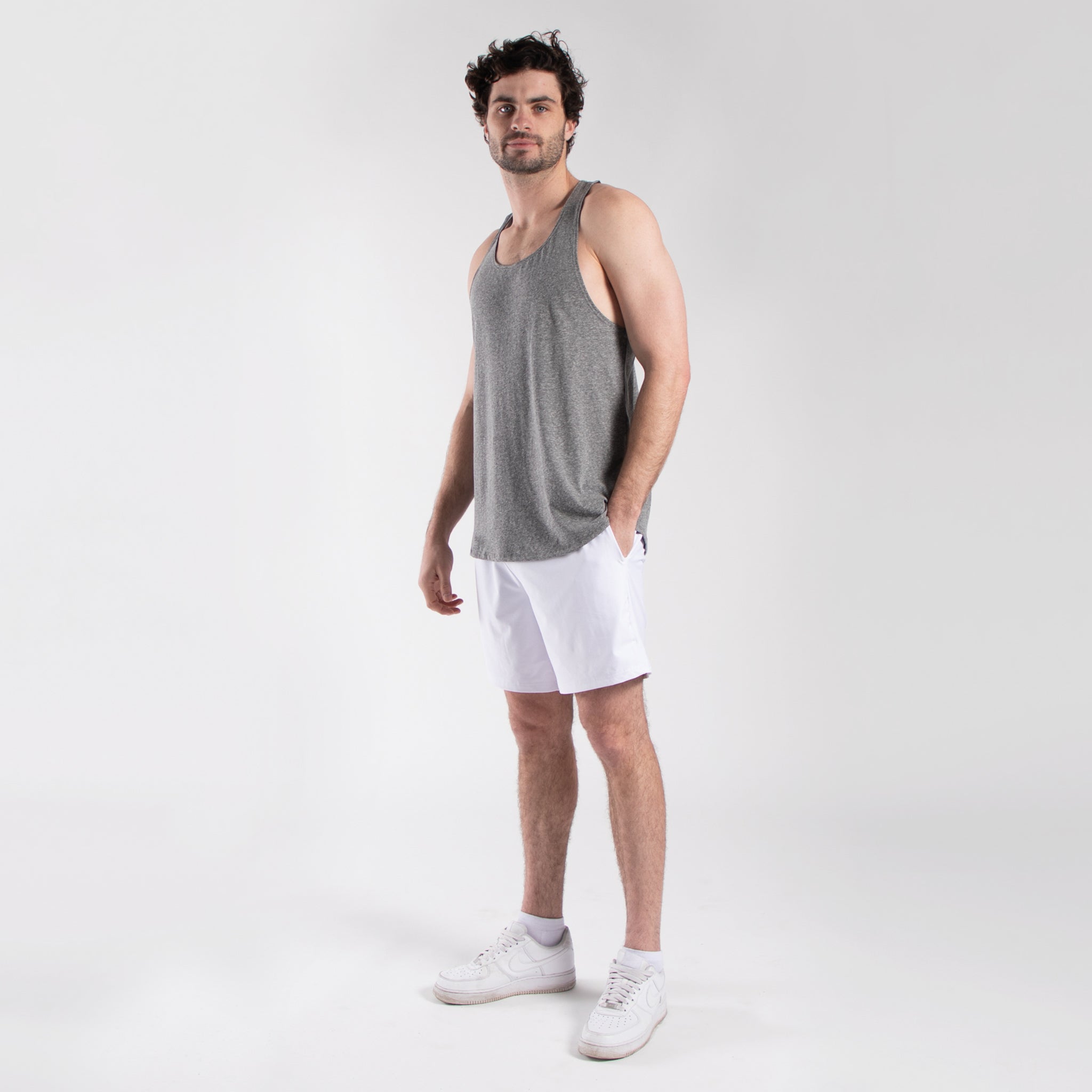 Men's seven-inch white athletic shorts with elastic waistband and side pockets made of lightweight nylon — view 2