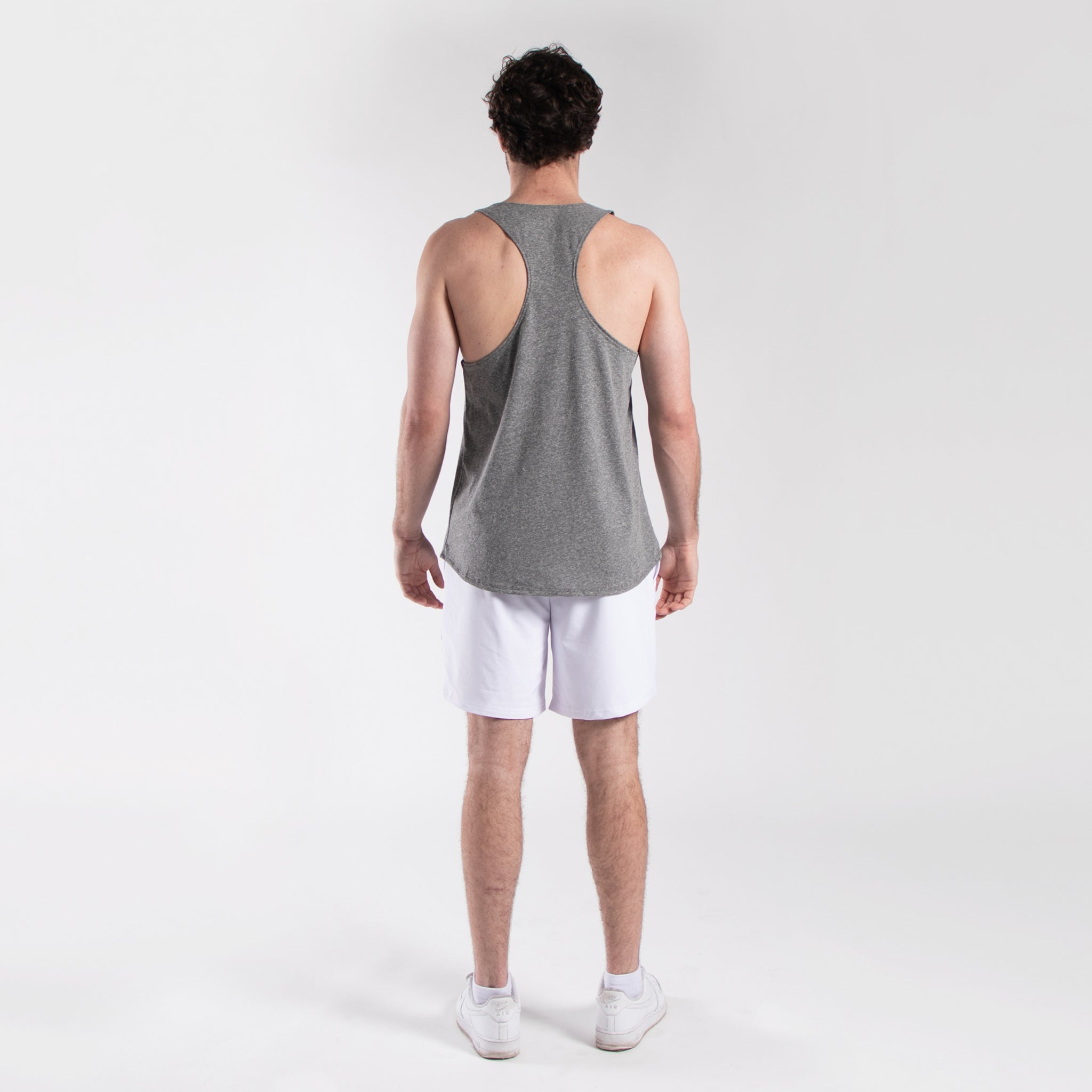 Men's seven-inch white athletic shorts with elastic waistband and side pockets made of lightweight nylon — view 3