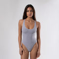 Women's seamless cotton racerback bodysuit in a form-fitting design with a rounded neckline