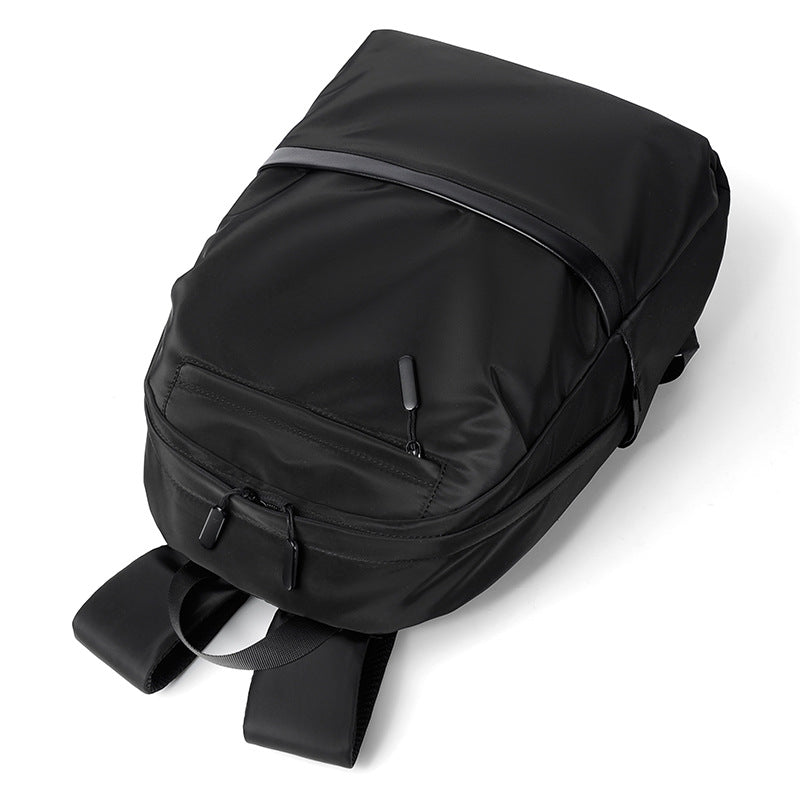 Minimalist black waterproof nylon laptop backpack with zippered pockets for urban commuting and travel — view 3