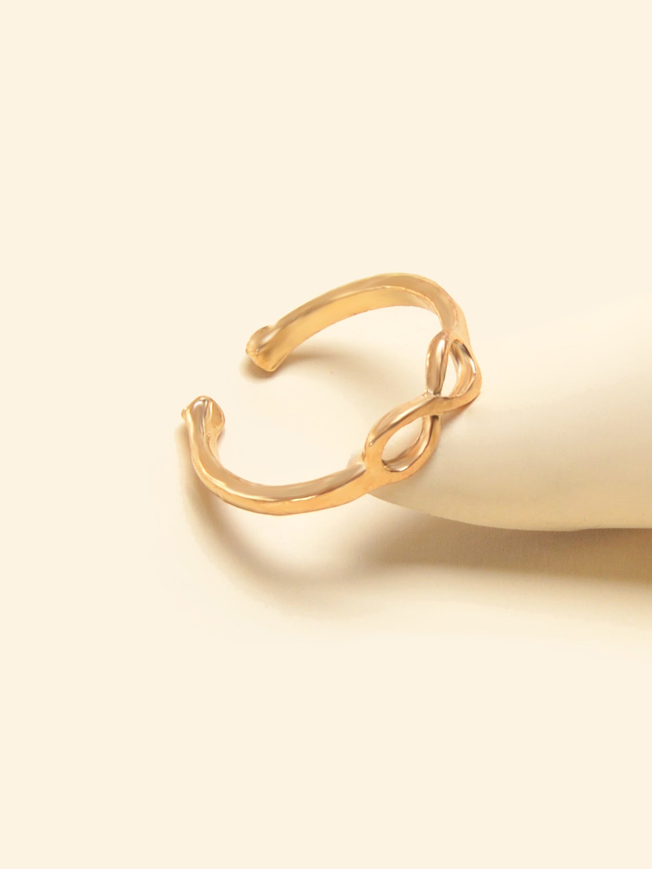 Gold geometric toe and finger ring jewelry piece on a clean white background. — view 2