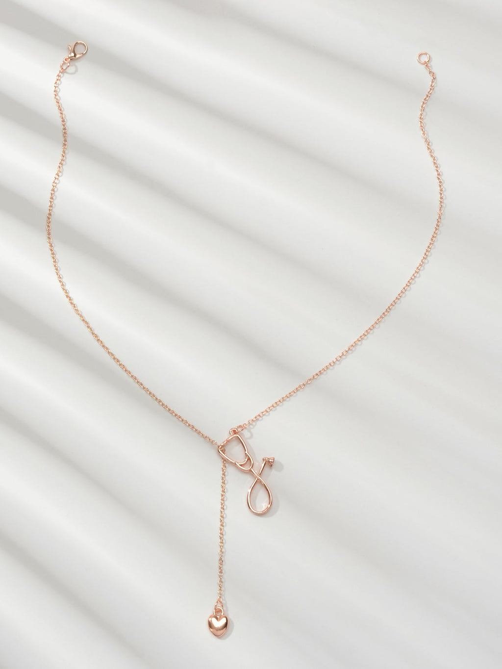 Minimalist gold and silver stethoscope heart pendant Y-shape necklace on a delicate chain — view 2