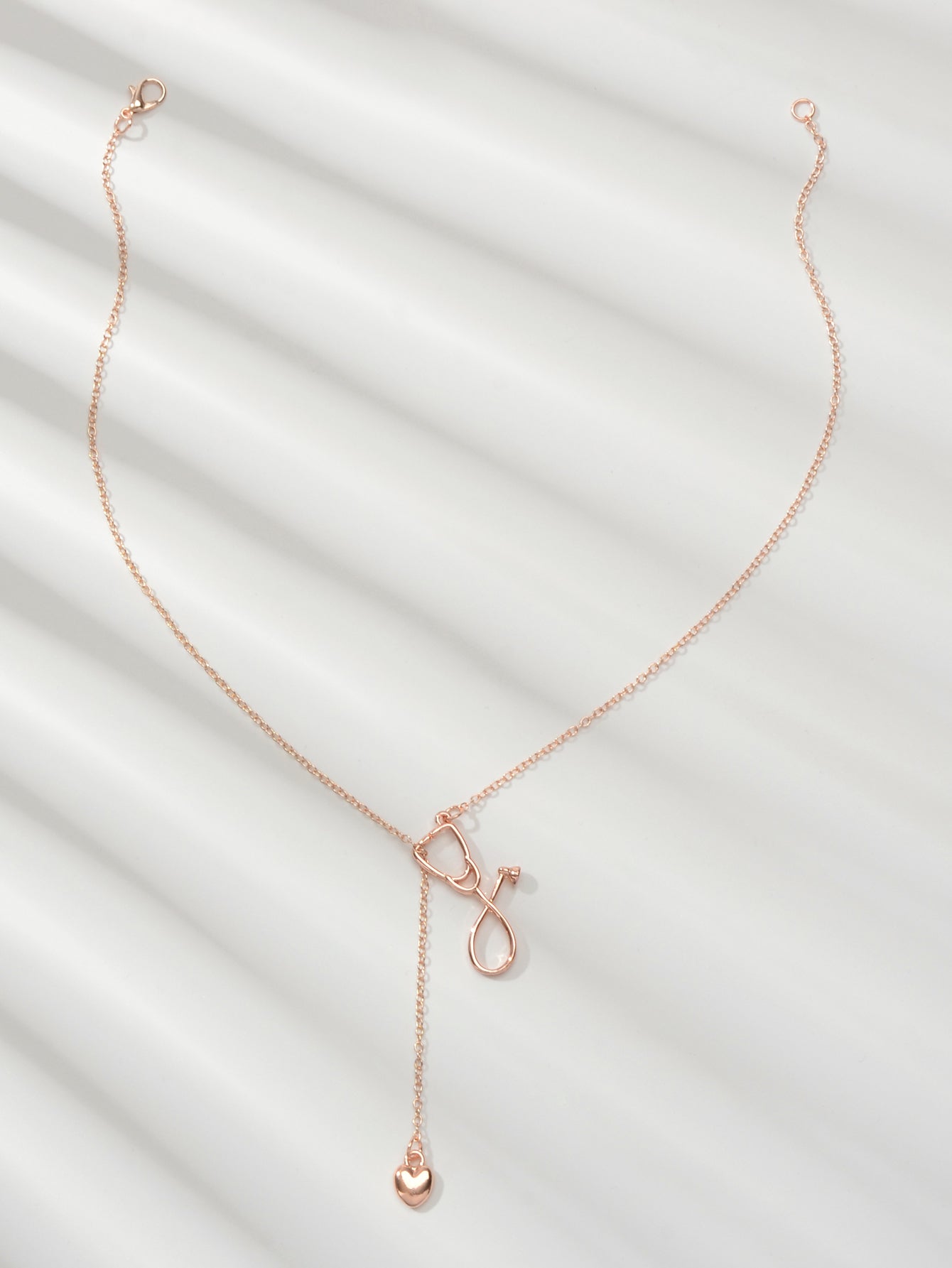 Minimalist gold and silver stethoscope heart pendant Y-shape necklace on a delicate chain — view 2