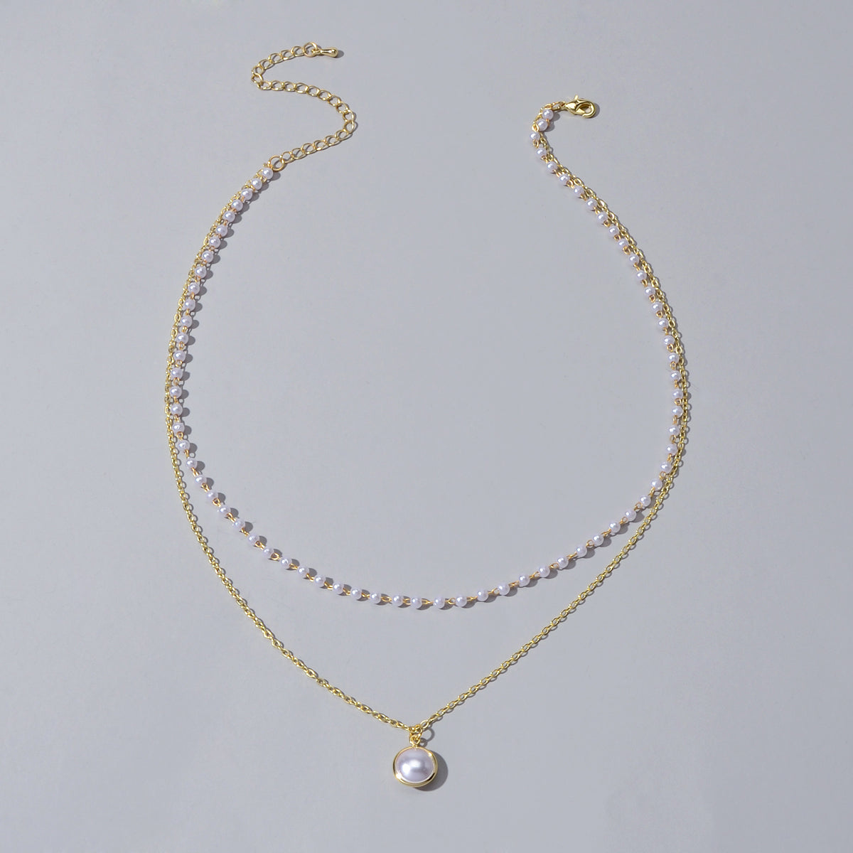 Retro gold double layer chain necklace featuring a classic lustrous pearl pendant for women — view 2