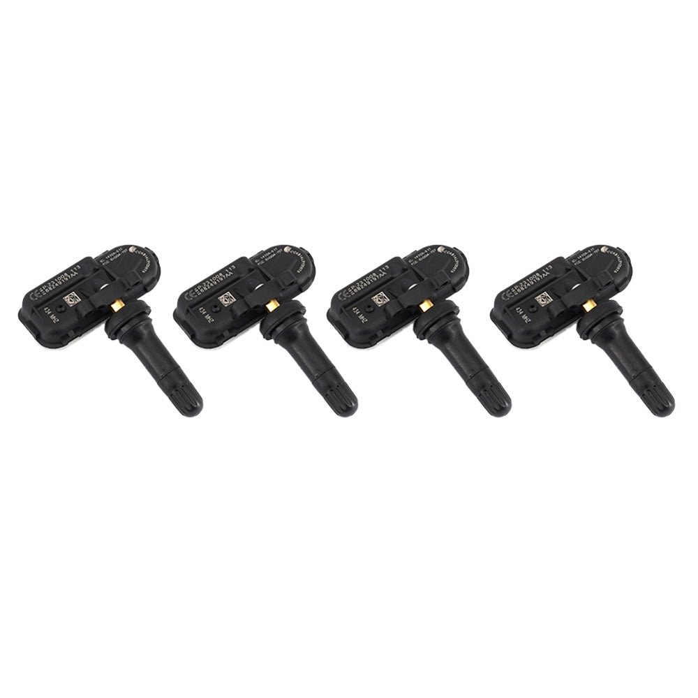 Four black automotive tyre pressure monitoring sensors arranged on a clean white background