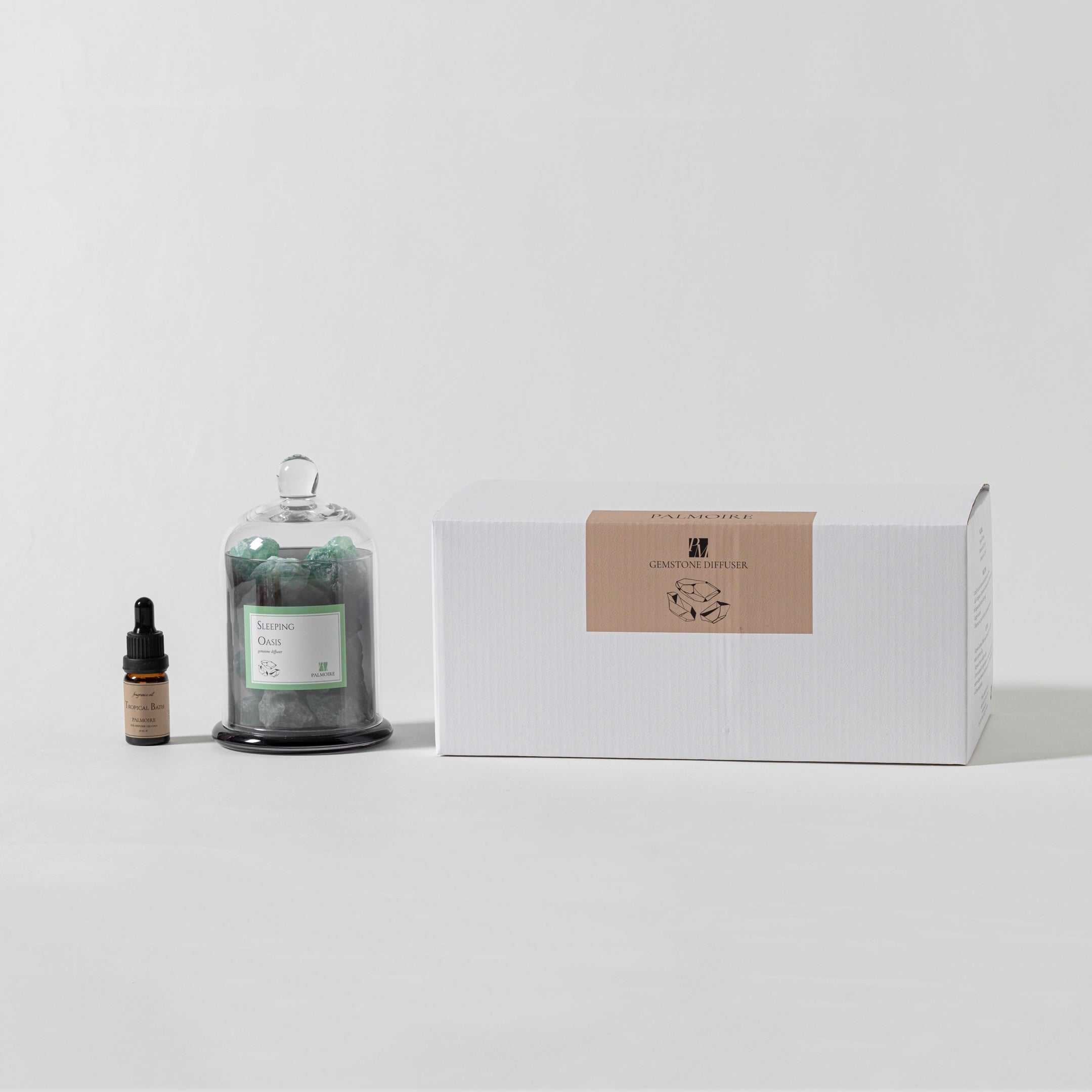 Sleeping Oasis gemstone diffuser with natural stones and Tropical Bath fragrance oil bottle. — view 5