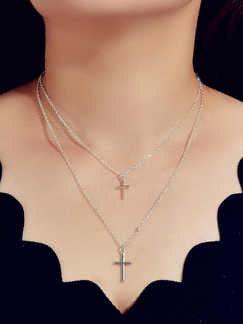 Silver double layer cross necklace featuring delicate chains and a minimalist pendant for women