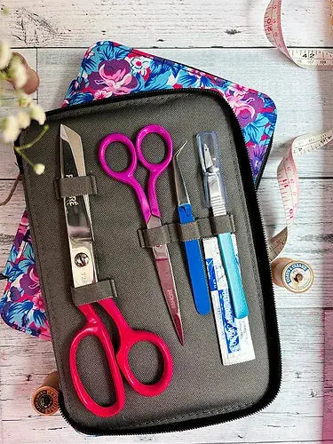 Four piece floral pattern sewing kit with fabric shears trimming scissors tweezers and seam ripper