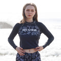 Women's black floral rashguard for water sports, featuring fade-resistant graphics and UV protection fabric