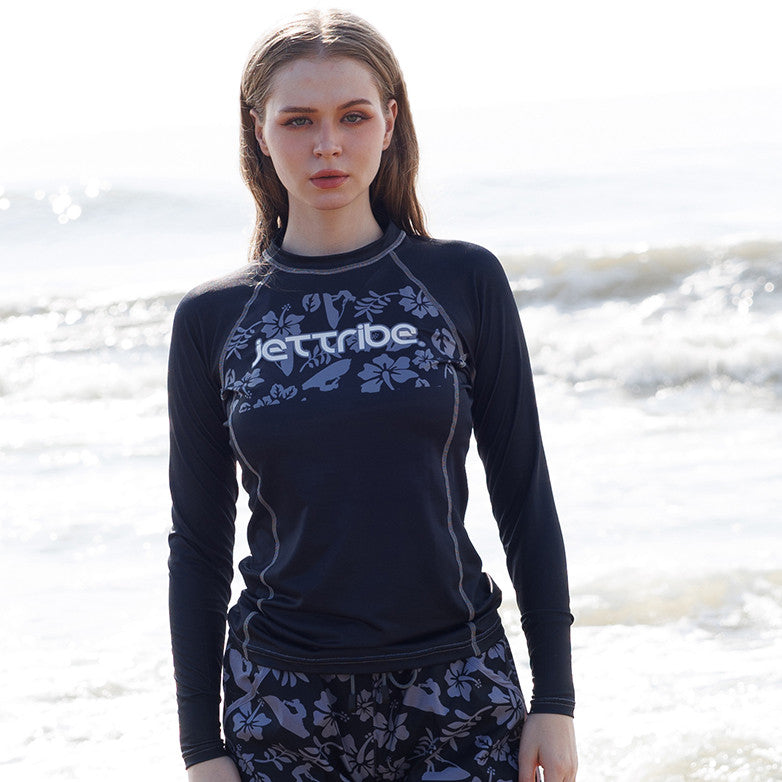 Women's black floral rashguard for water sports, featuring fade-resistant graphics and UV protection fabric — view 2