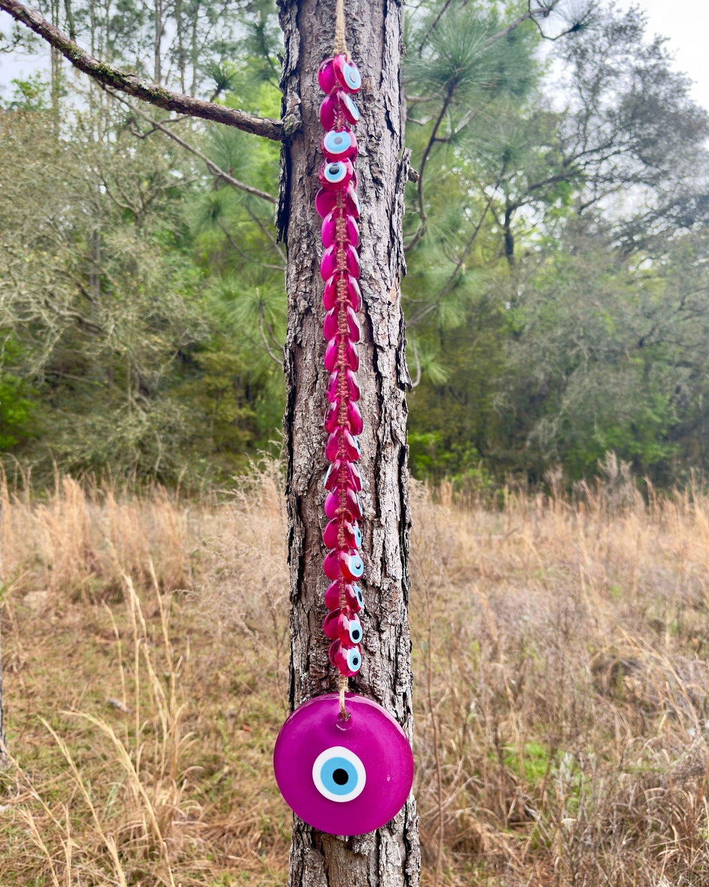 Pink evil eye wall hanging decor with 41 handblown glass beads and intricate macrame detailing. — view 2