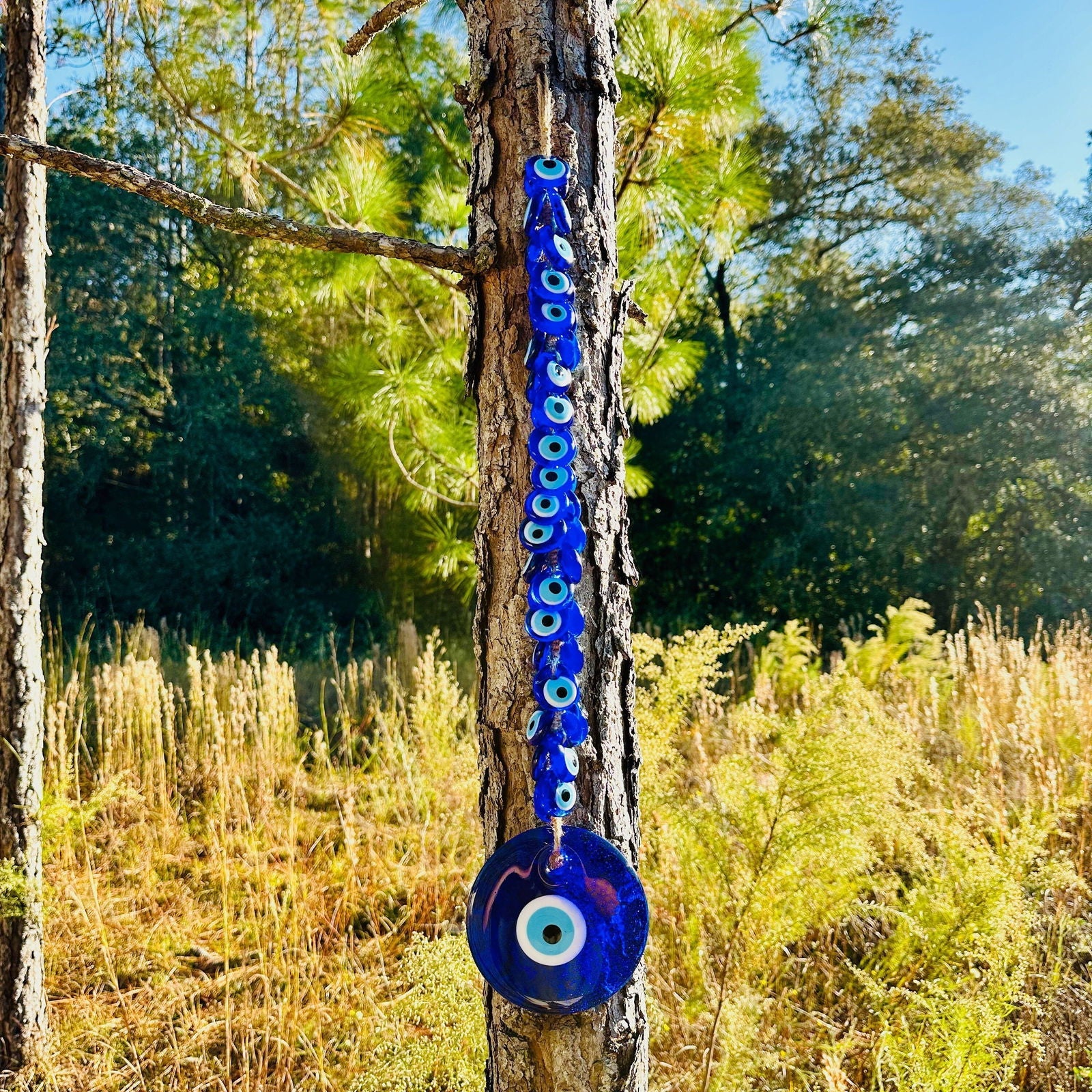 Large blue glass evil eye wall hanging with 40 smaller macrame beads for home protection. — view 2