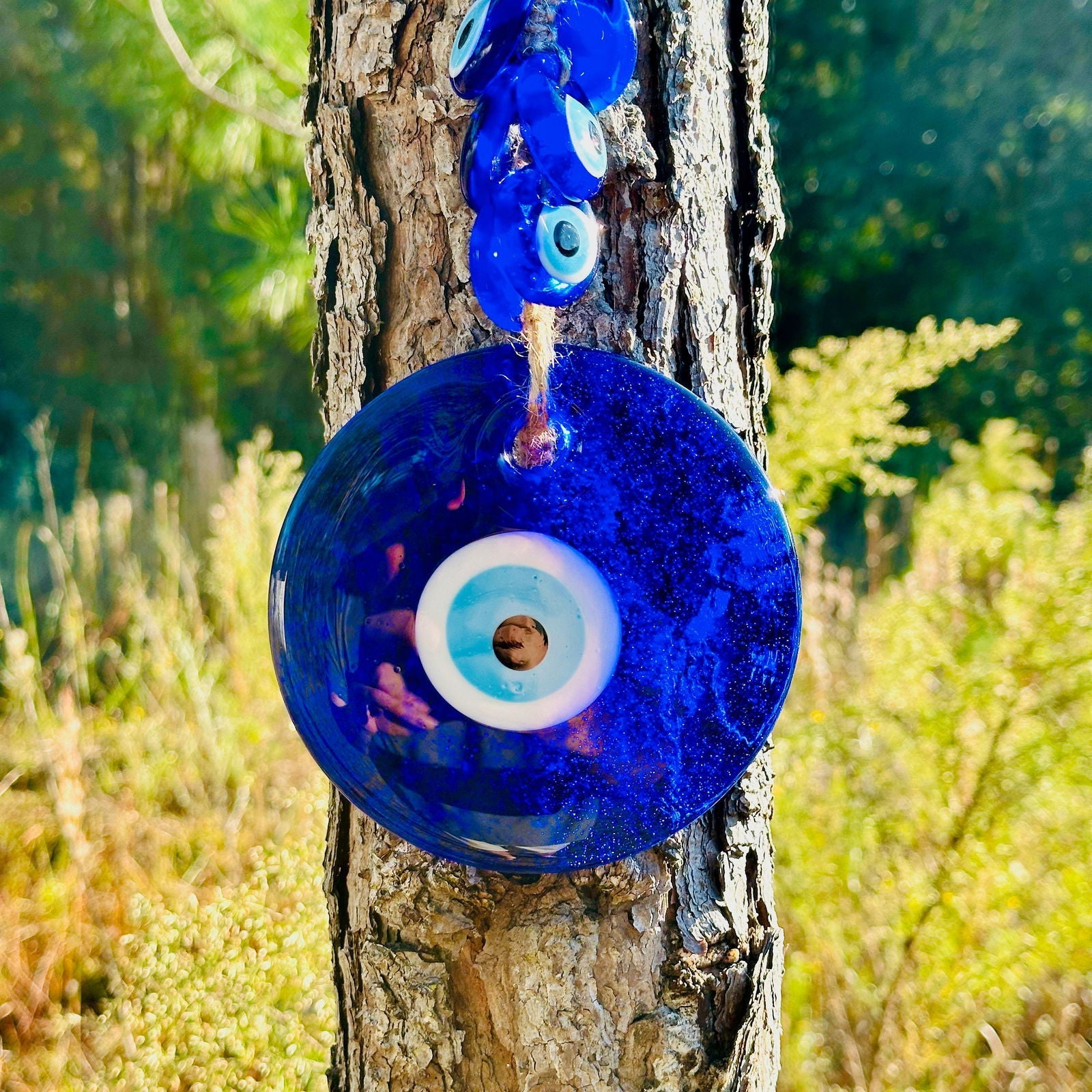 Large blue glass evil eye wall hanging with 40 smaller macrame beads for home protection. — view 4