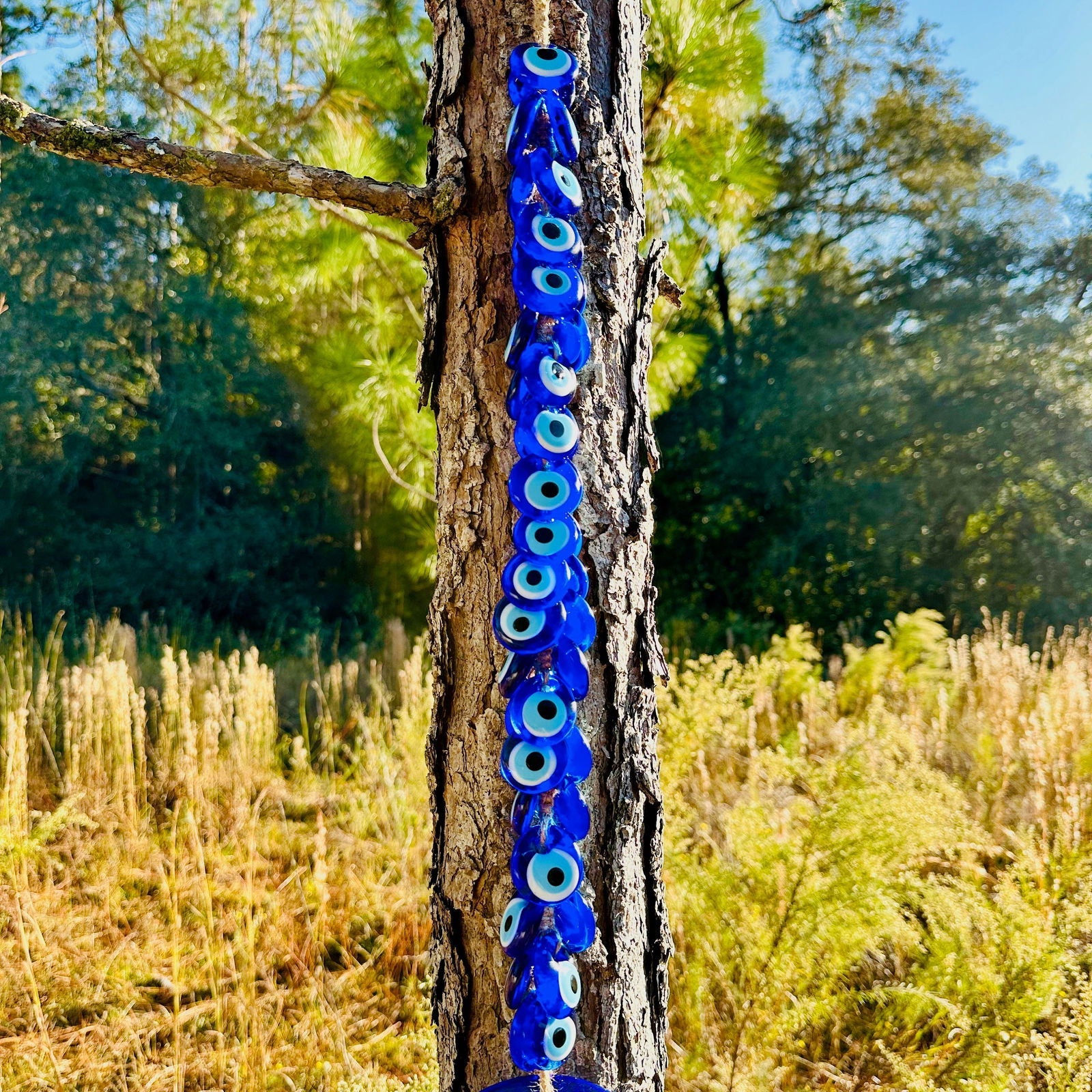 Large blue glass evil eye wall hanging with 40 smaller macrame beads for home protection. — view 3
