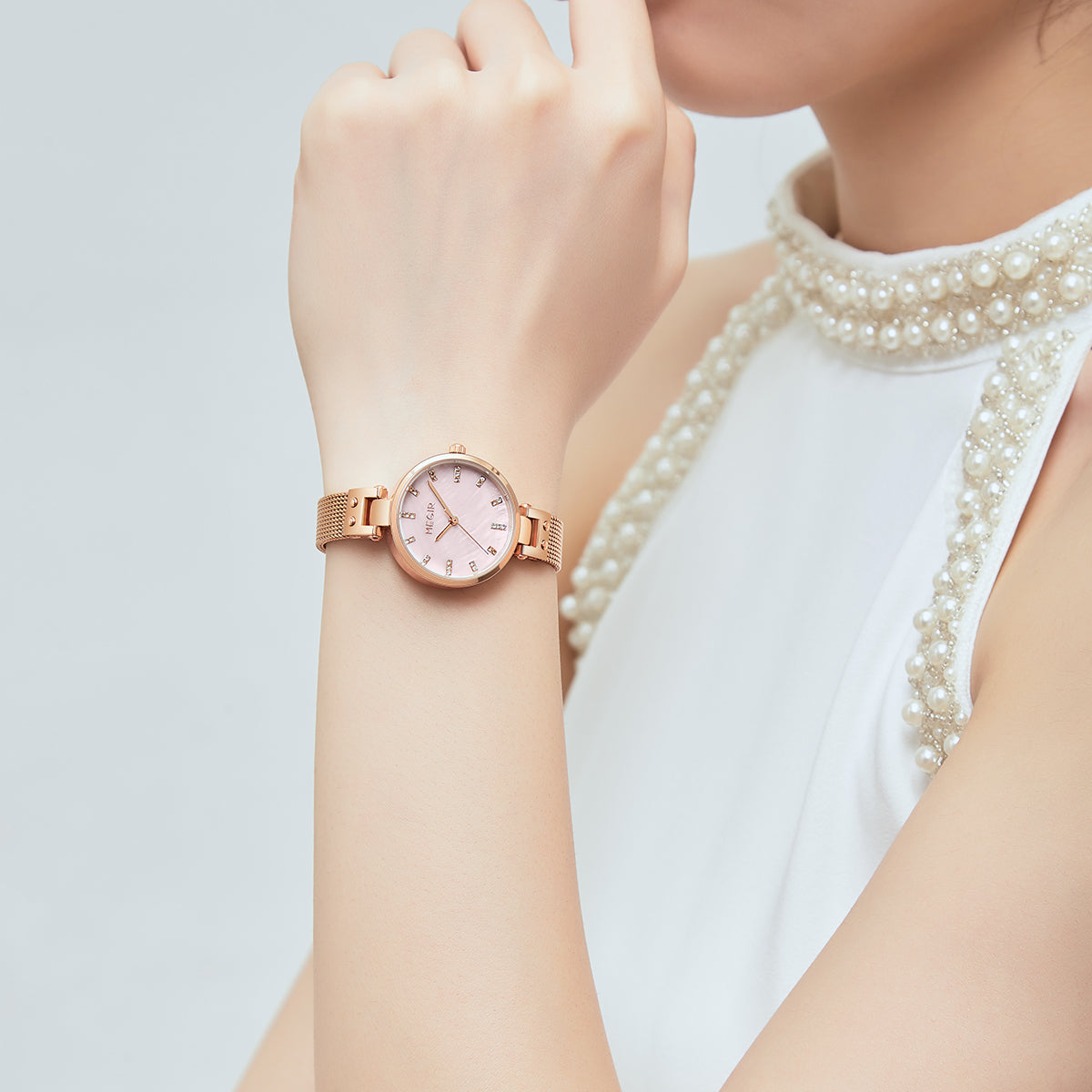 Women's quartz wristwatch featuring a round brass case and elegant metallic mesh steel band. — view 2