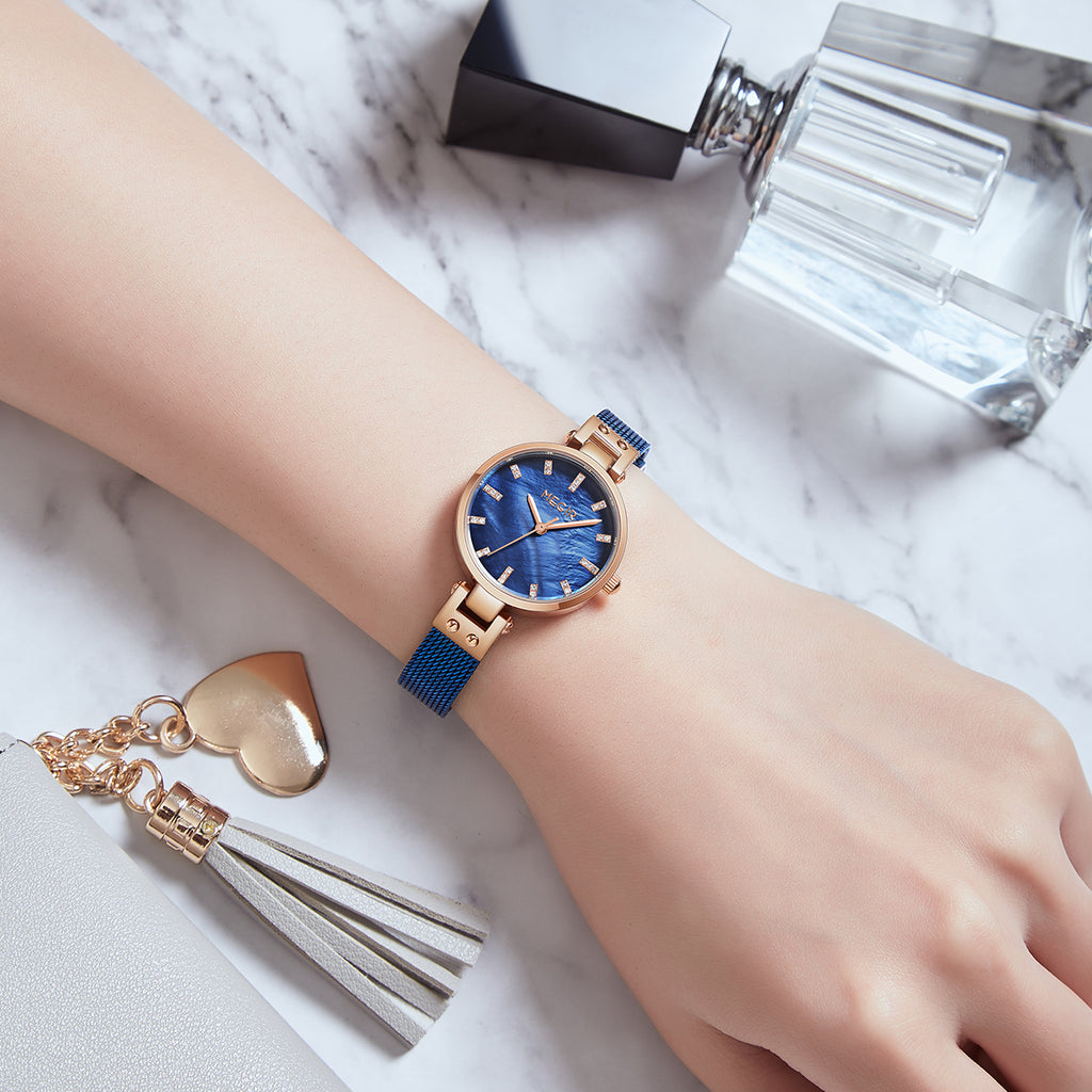 Women's quartz wristwatch featuring a round brass case and elegant metallic mesh steel band. — view 6