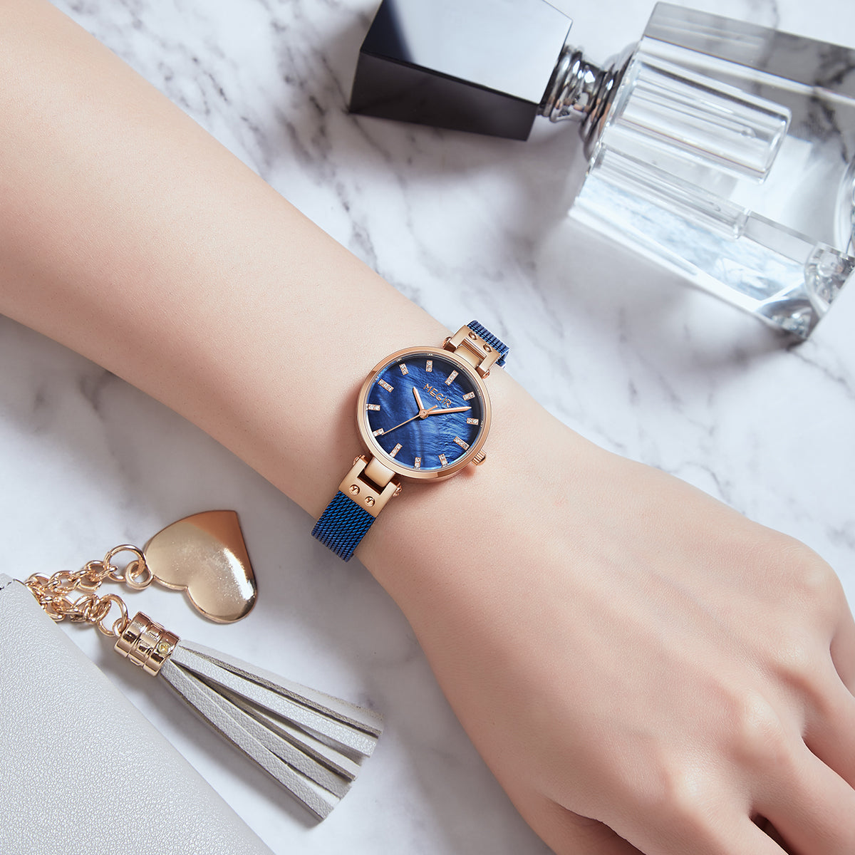 Women's quartz wristwatch featuring a round brass case and elegant metallic mesh steel band. — view 6