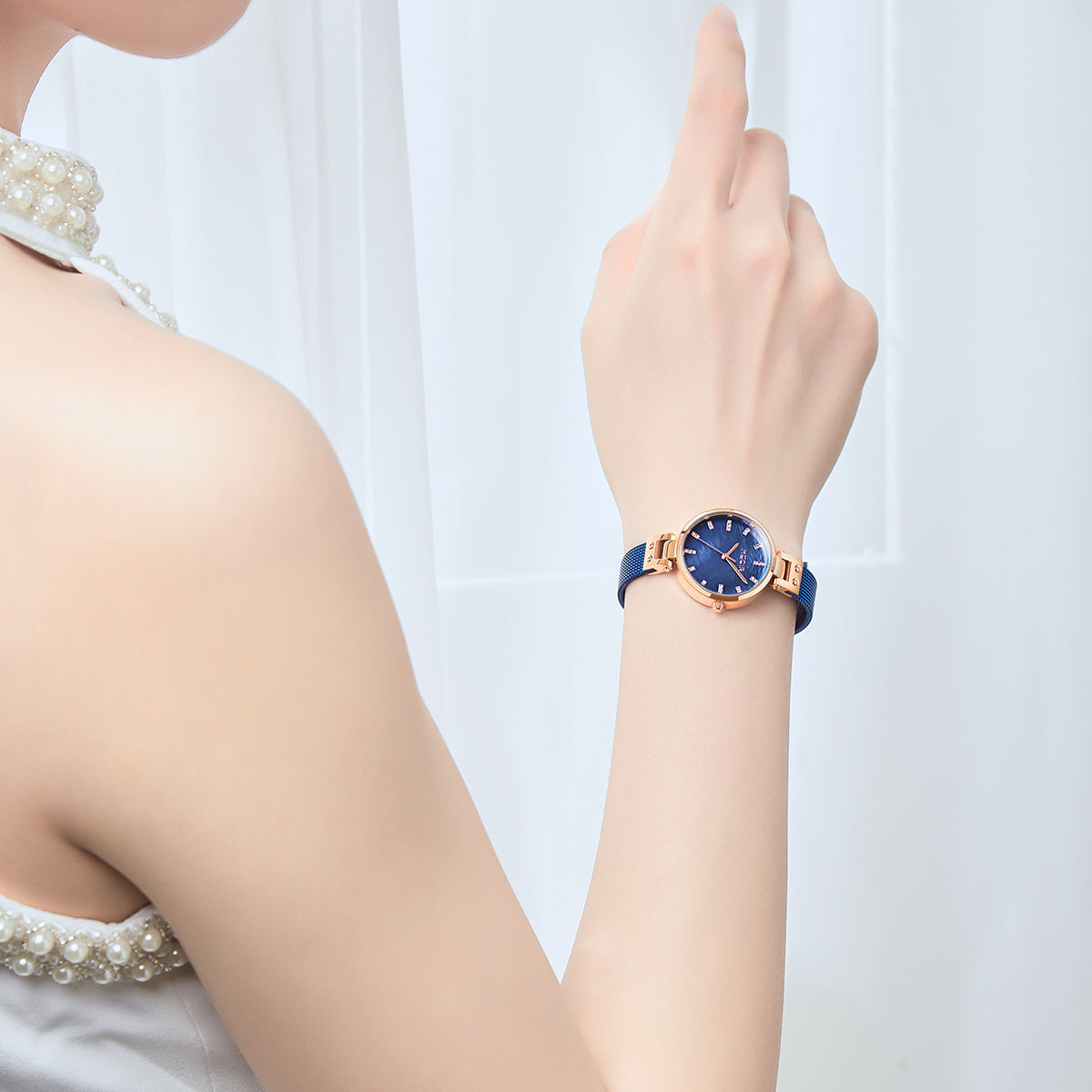 Women's quartz wristwatch featuring a round brass case and elegant metallic mesh steel band. — view 7
