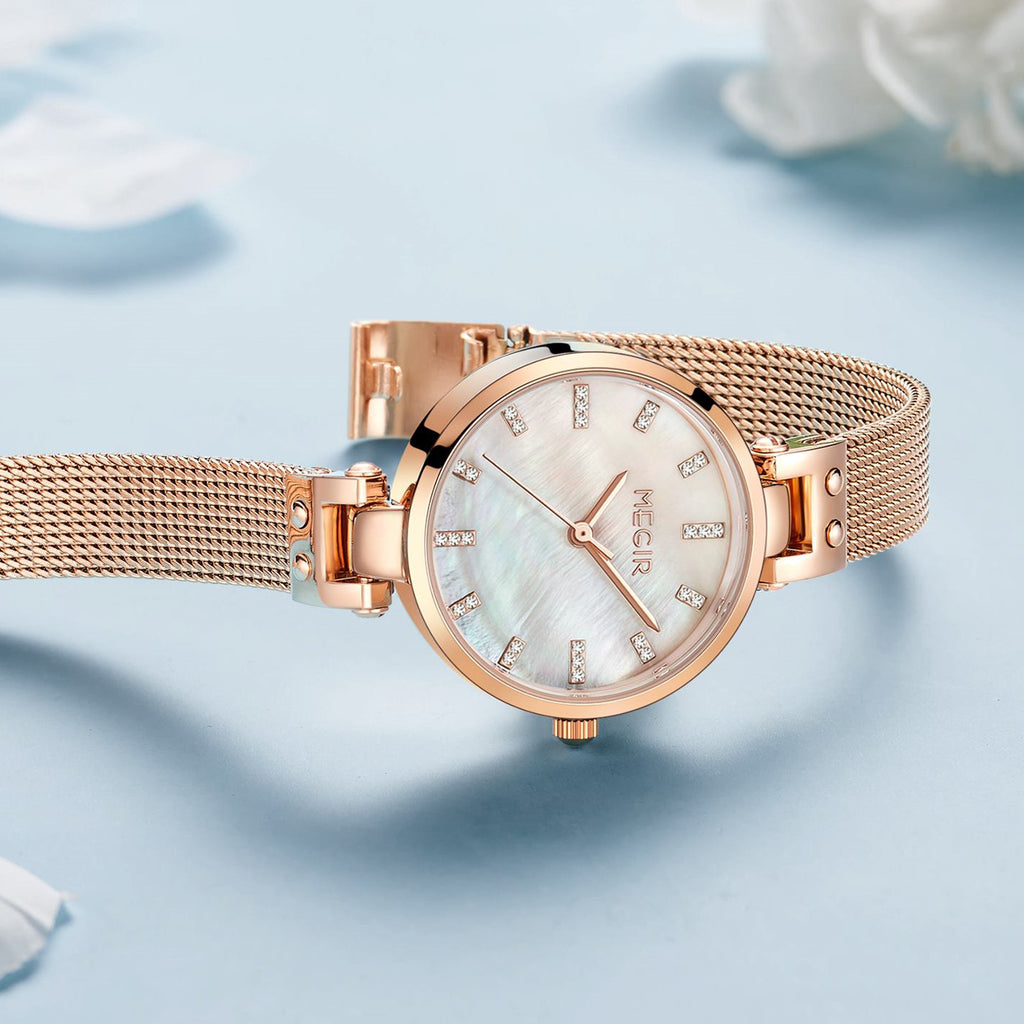 Women's quartz wristwatch featuring a round brass case and elegant metallic mesh steel band. — view 11