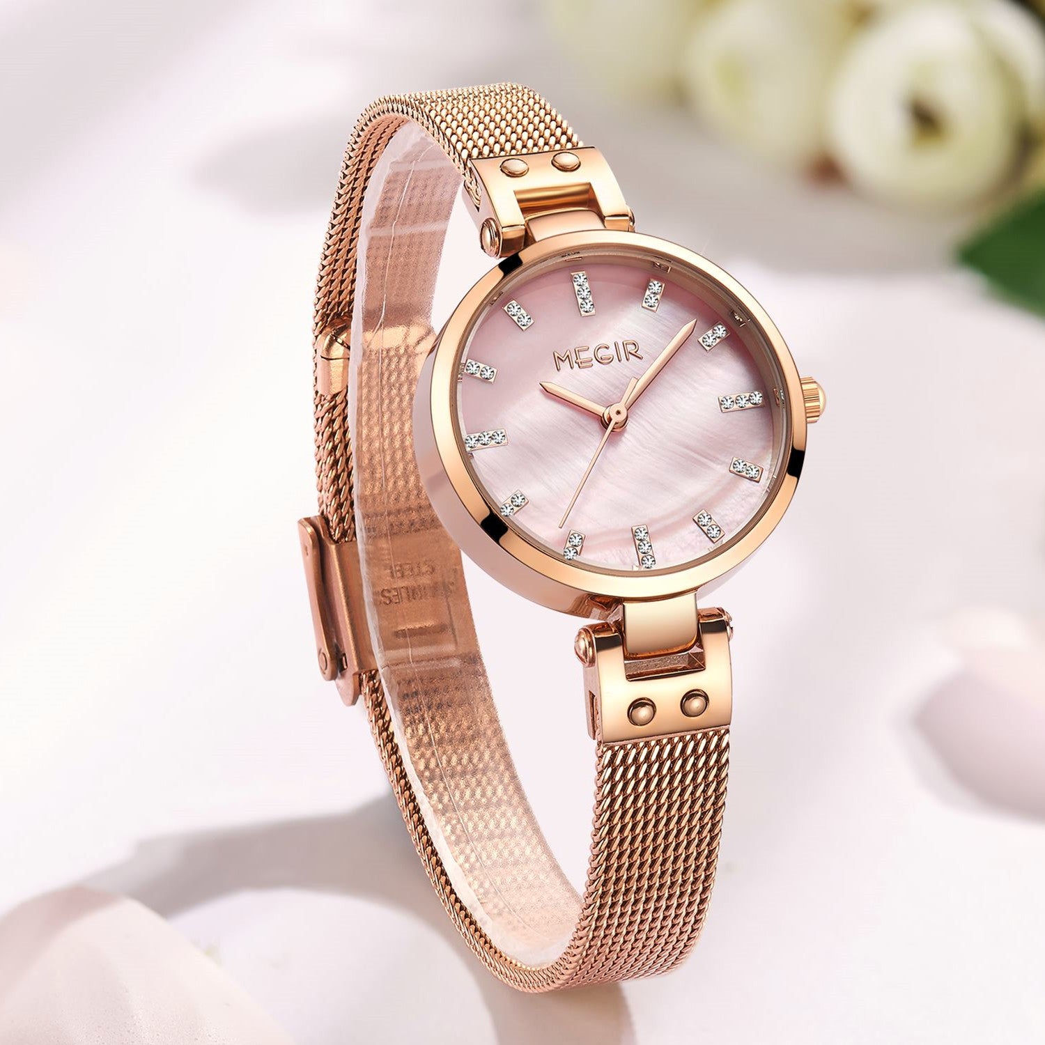 Women's quartz wristwatch featuring a round brass case and elegant metallic mesh steel band. — view 9