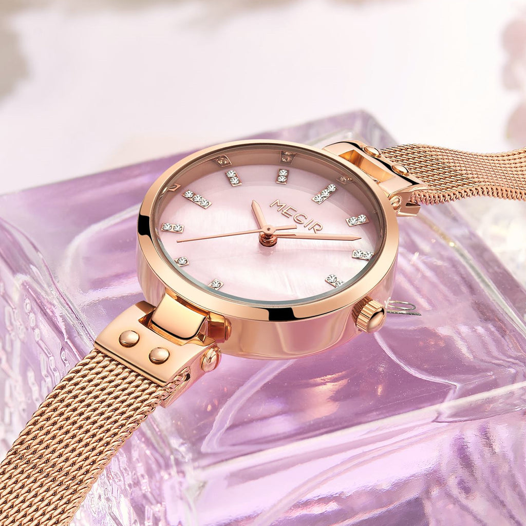 Women's quartz wristwatch featuring a round brass case and elegant metallic mesh steel band. — view 12
