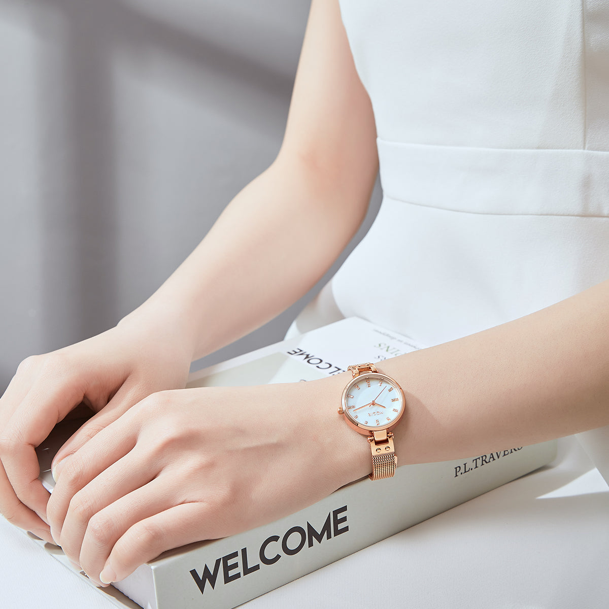 Women's quartz wristwatch featuring a round brass case and elegant metallic mesh steel band. — view 4