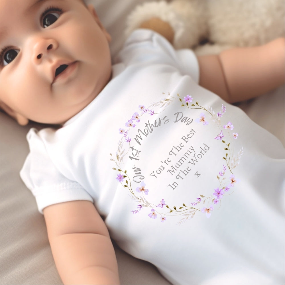 White baby grow, vest, and bib featuring a colorful floral first Mother's Day printed design — view 3