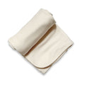 Cream baby bamboo swaddle blanket made of soft breathable fabric for comforting newborn sleep and nursing