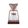 Cold coffee pour over kit featuring stainless steel stand, solid wood base, and glass dripper