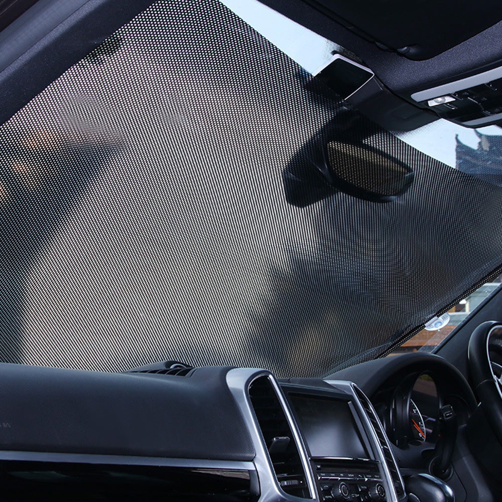 Black PVC retractable front windshield sun shade visor with suction cups mounted in car interior — view 5