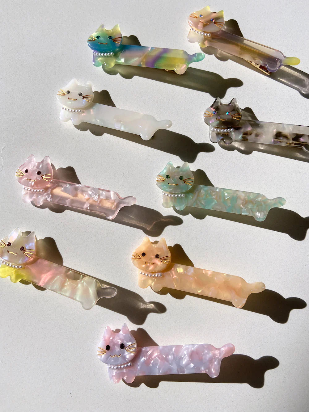 Hand-painted cat shaped eco-friendly cellulose acetate hair clip with pearl necklace and glass rhinestones.