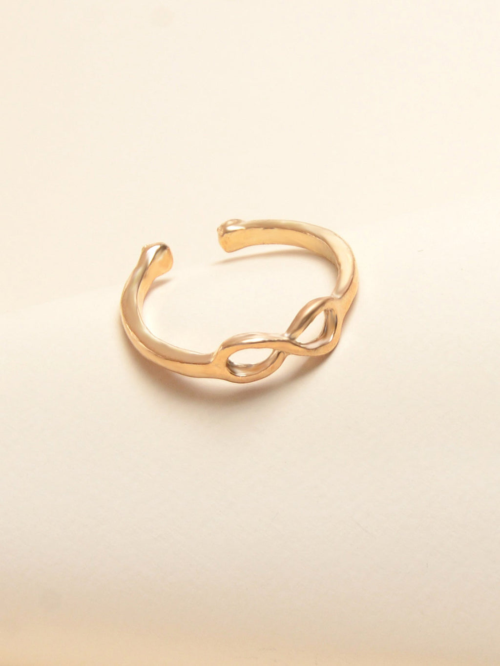 Gold geometric toe and finger ring jewelry piece on a clean white background. — view 3