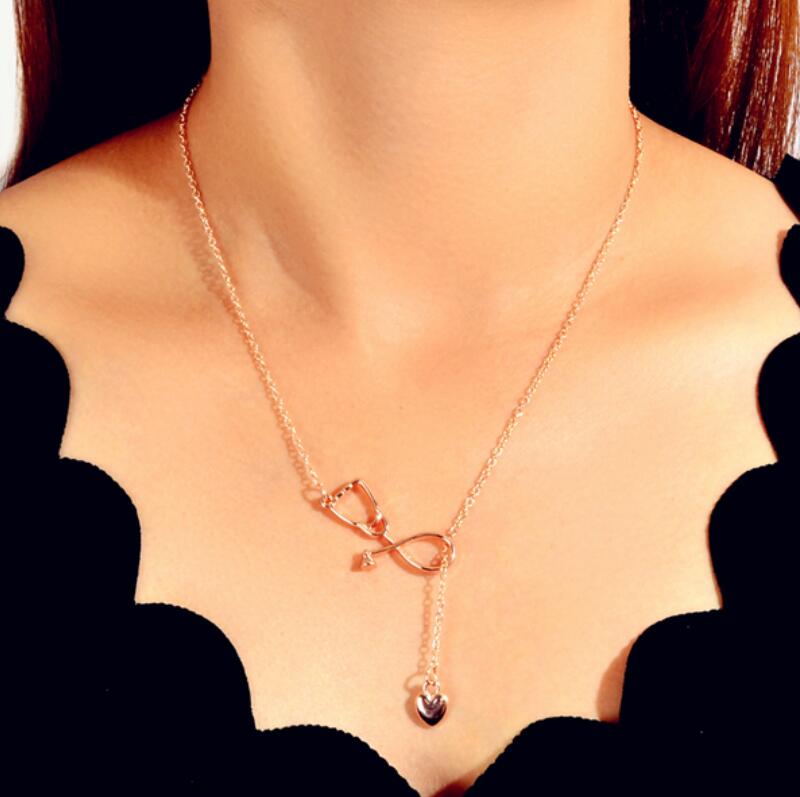 Minimalist gold and silver stethoscope heart pendant Y-shape necklace on a delicate chain — view 3