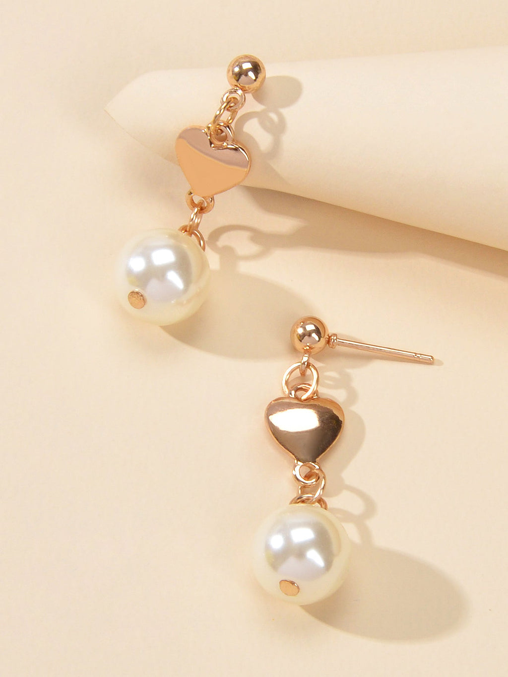 Gold heart drop earrings with simulated pearls for weddings and anniversaries on a white background — view 3