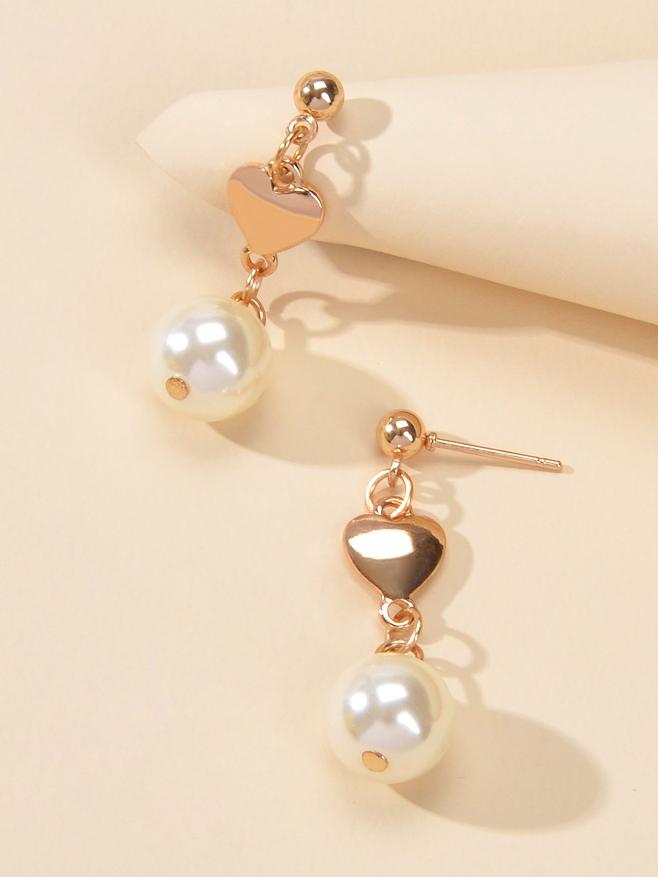Gold heart drop earrings with simulated pearls for weddings and anniversaries on a white background — view 3