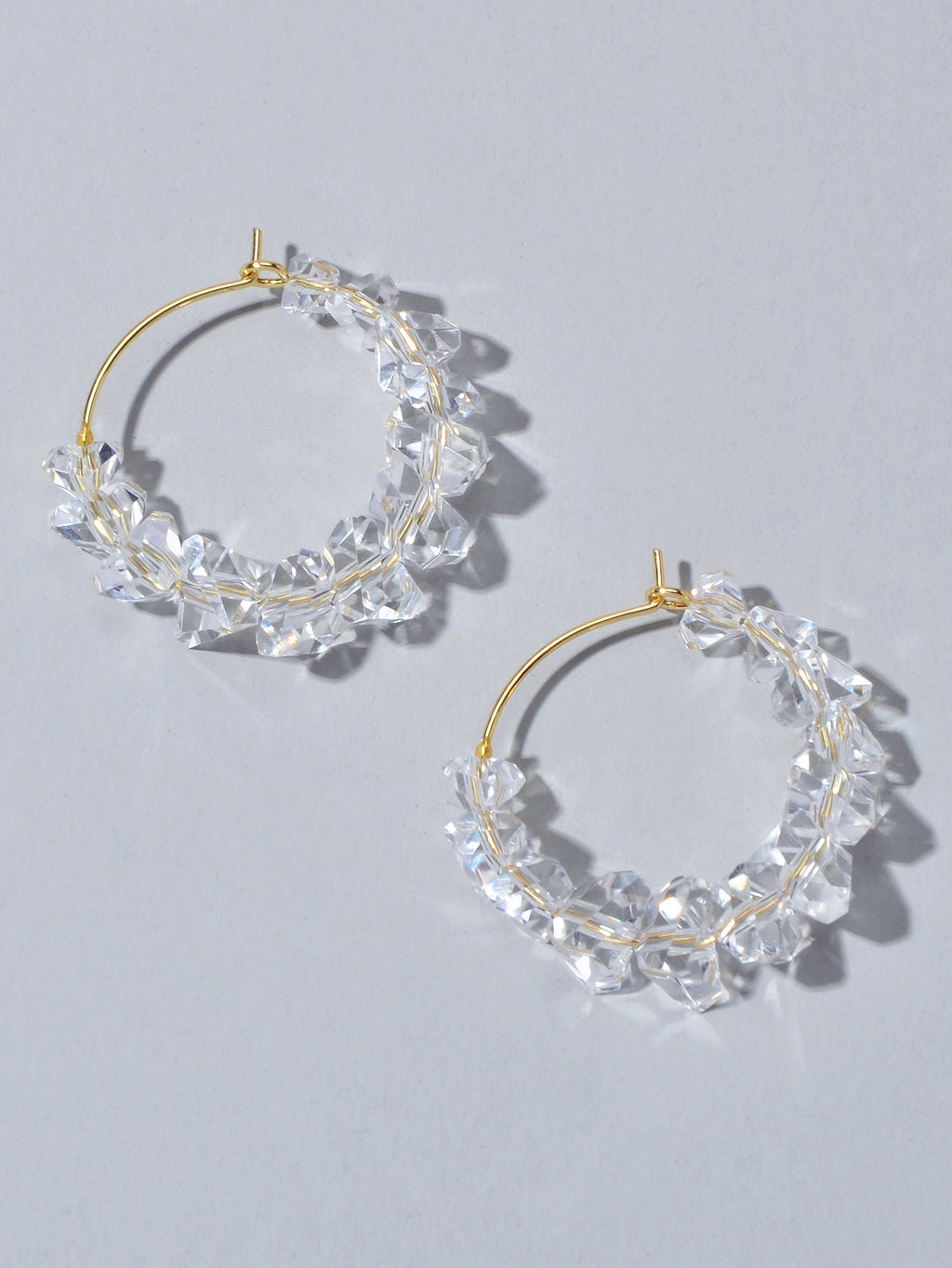 Transparent acrylic bead hoop dangle earrings for women on a clean background. — view 3