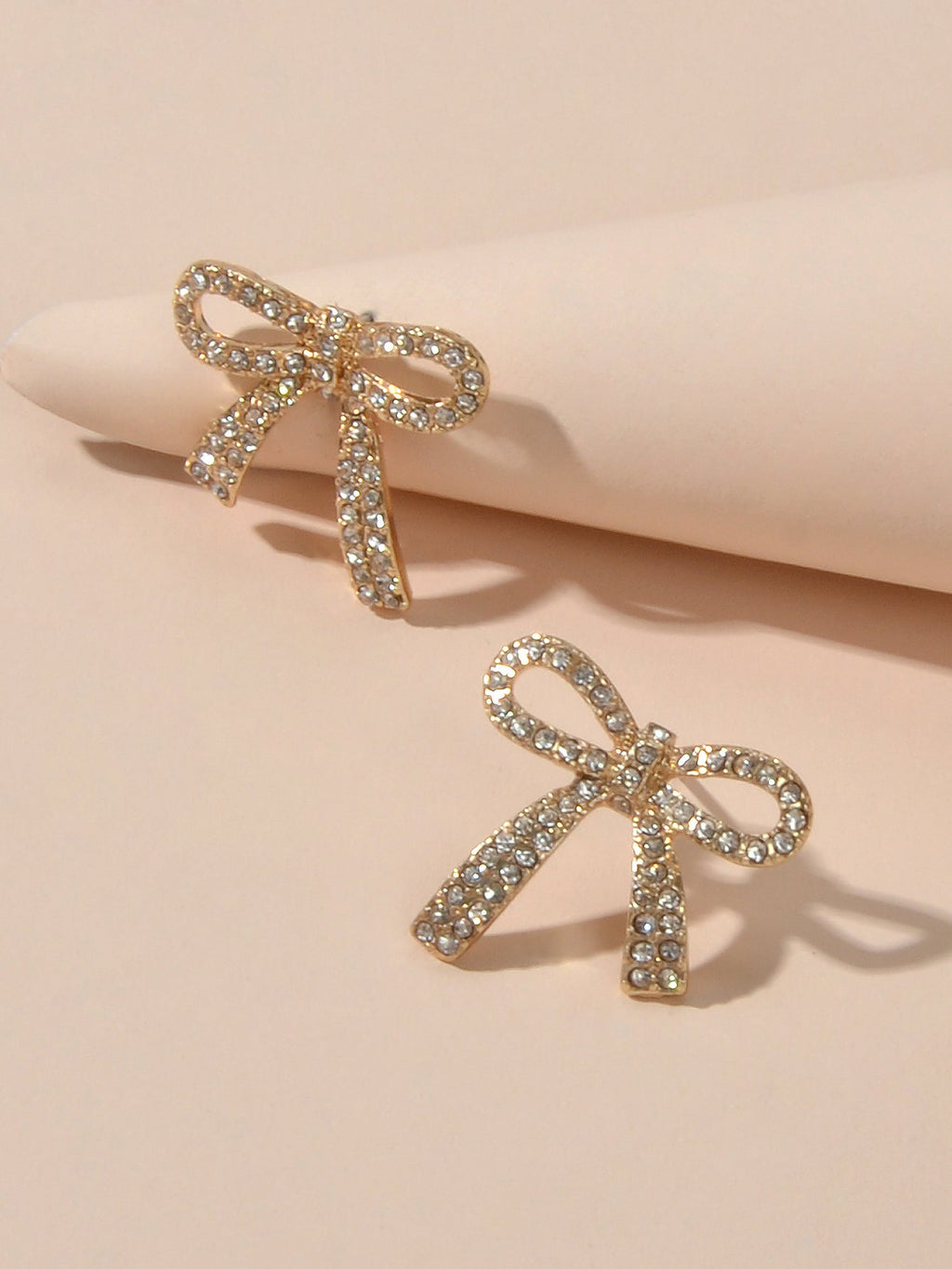 Sparkly rhinestone bow-knot stud earrings with a gold plated finish for elegant party wear. — view 3