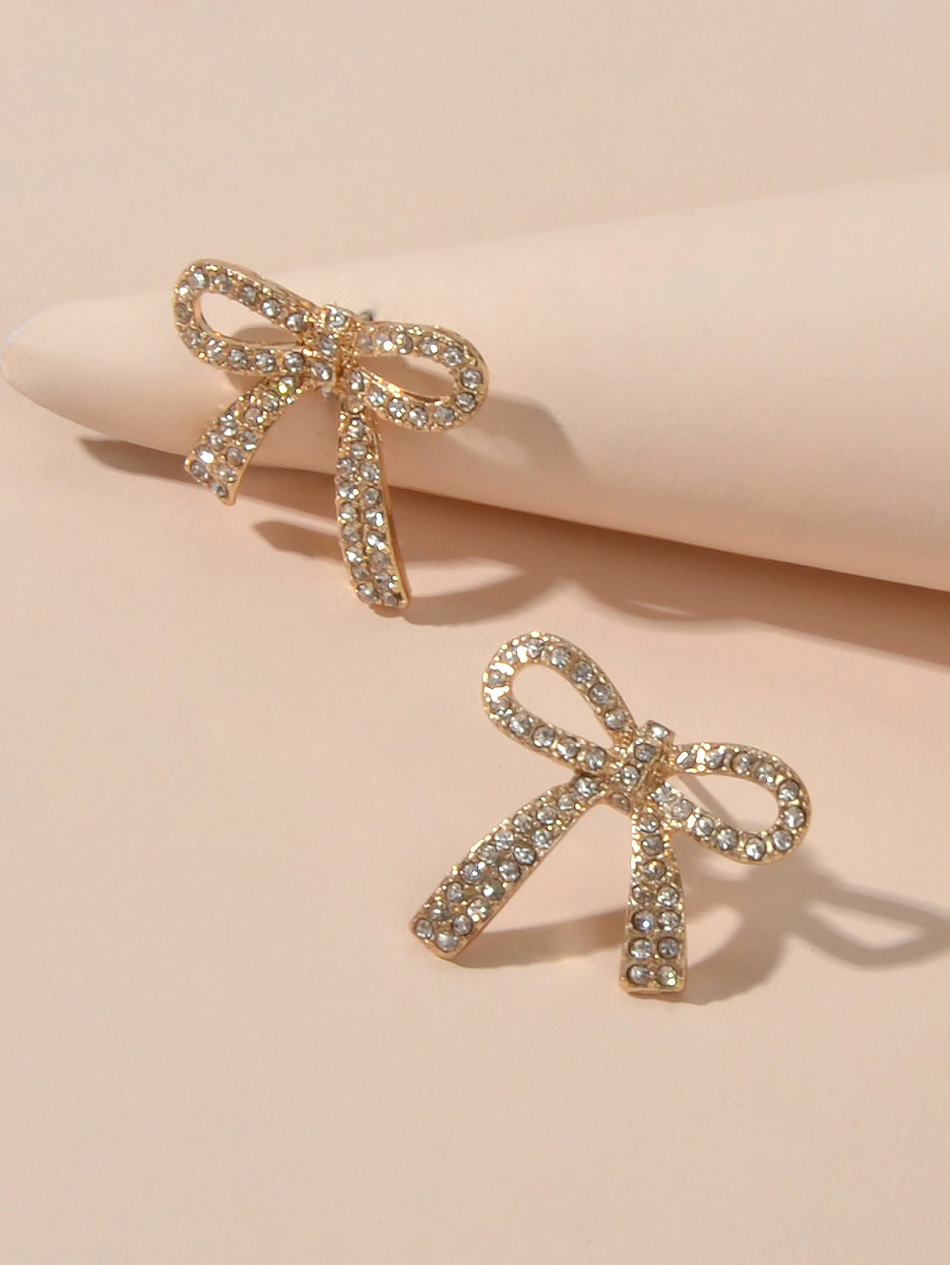 Sparkly rhinestone bow-knot stud earrings with a gold plated finish for elegant party wear. — view 3