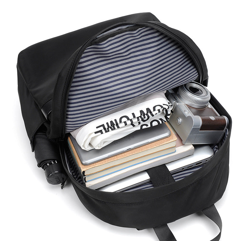 Minimalist black waterproof nylon laptop backpack with zippered pockets for urban commuting and travel — view 4