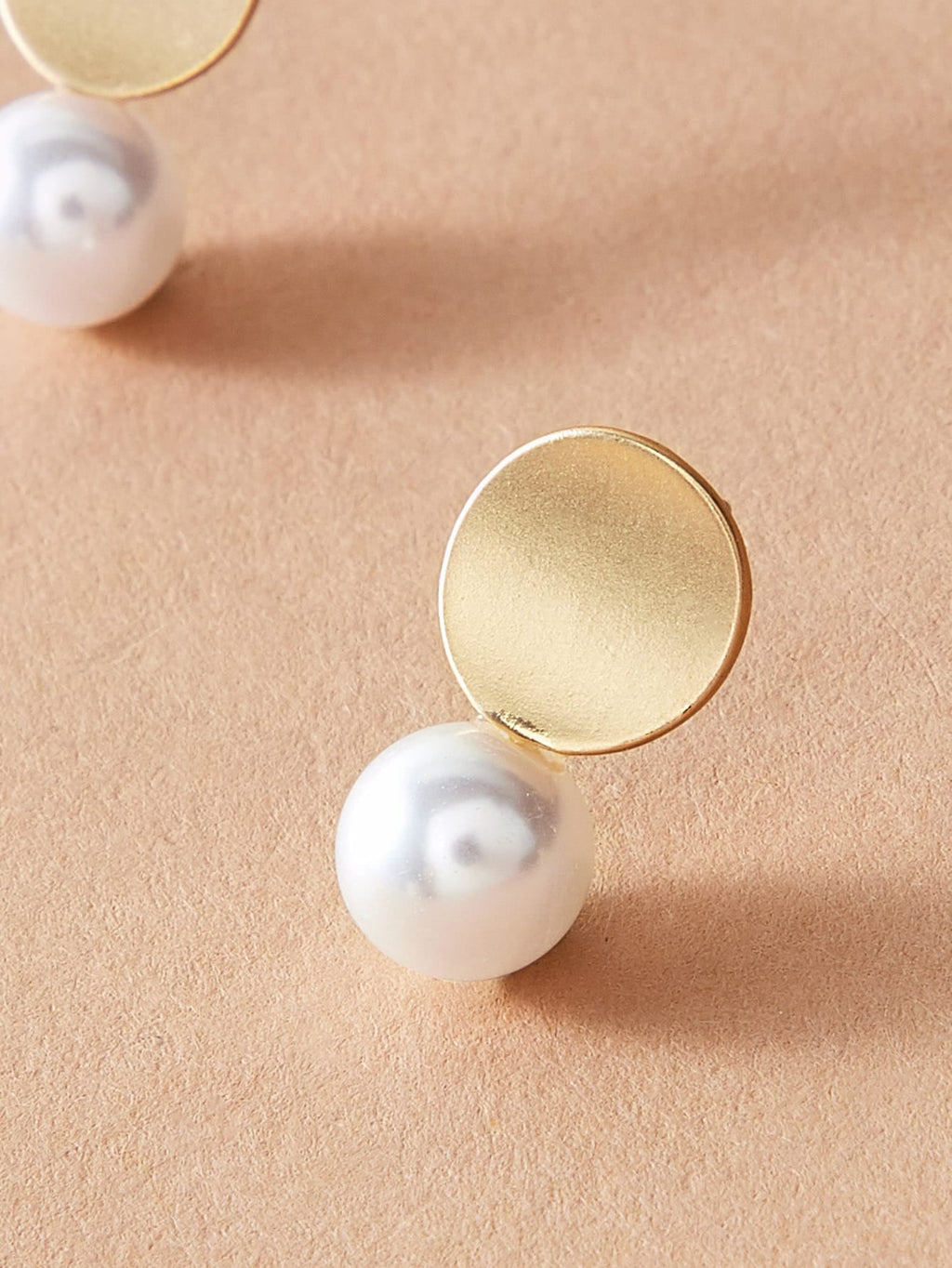 Dainty round gold metal faux pearl stud earrings for daily wear and elegant occasions. — view 3
