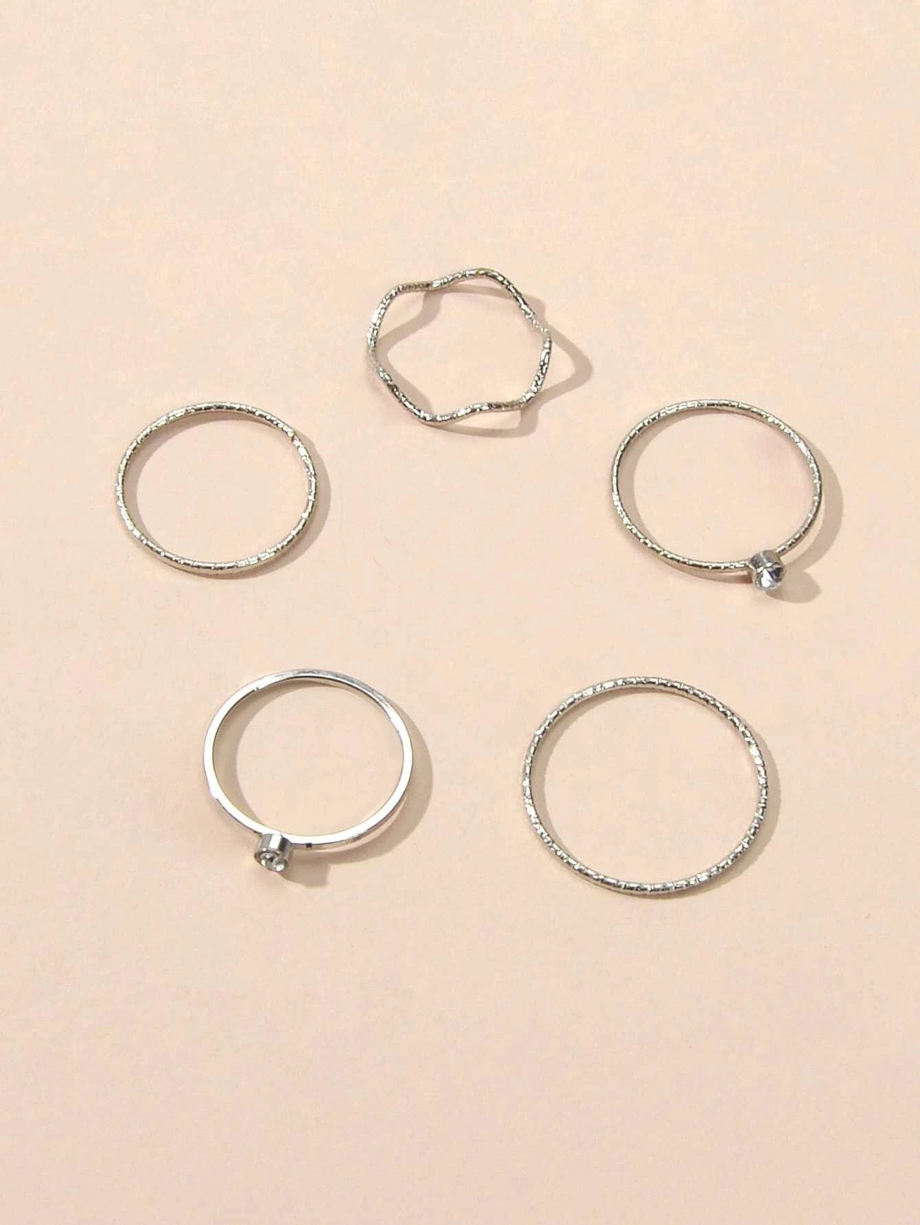 Silver double layer star pendant necklace and five matching knuckle rings displayed together as a set — view 3